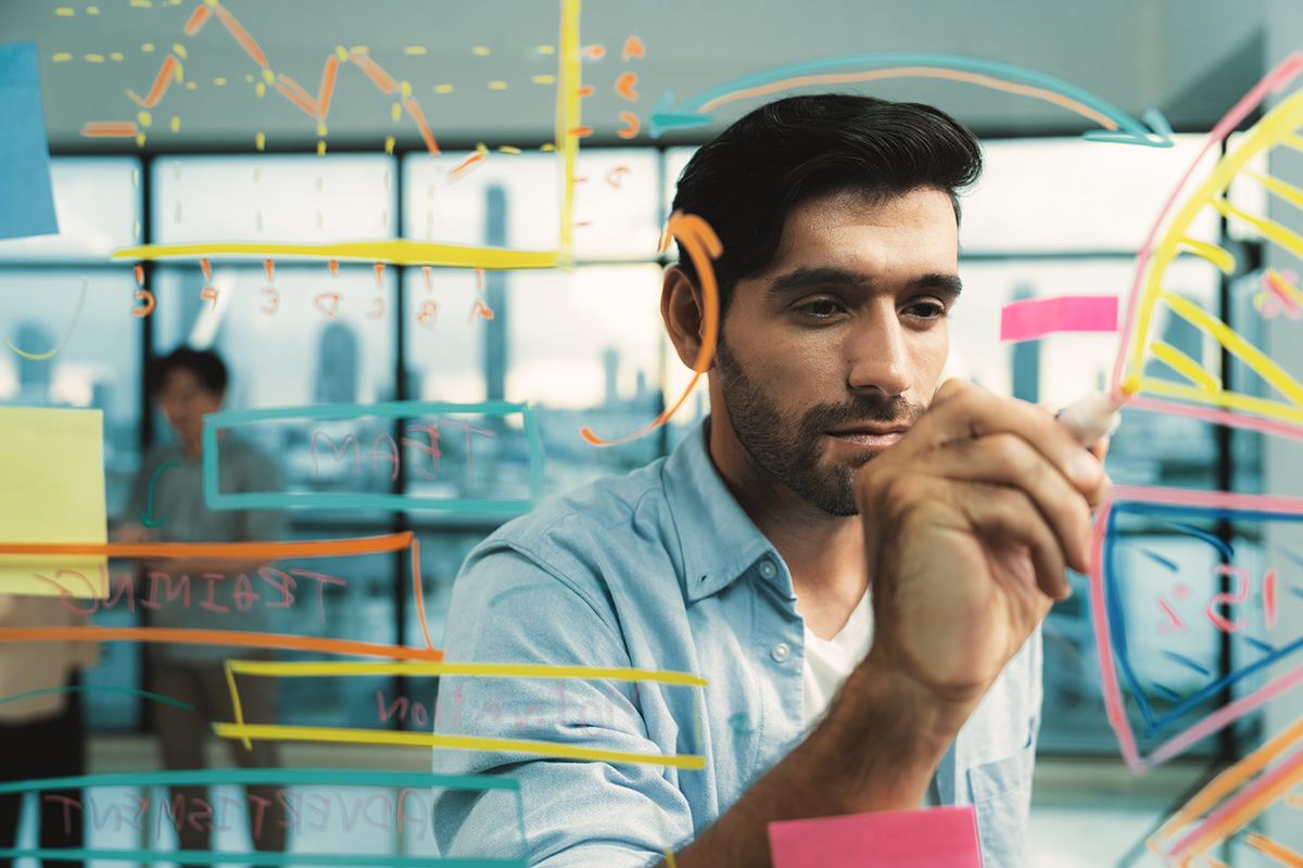 businessman writing marketing ideas