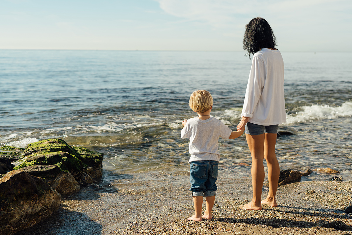 woman with young child at beach